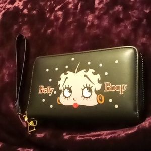 A  black small Betty Boop wrist wallet purse that's fits iphone without case.
